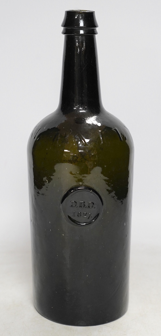 A George IV sealed wine bottle, DBD 1827, moulded script around shoulder, Imperial Patent, 29cm. Condition - commensurate with age